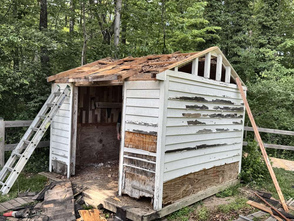 Gutted shed shell down to the framing during demolition in Davidsonville, MD
