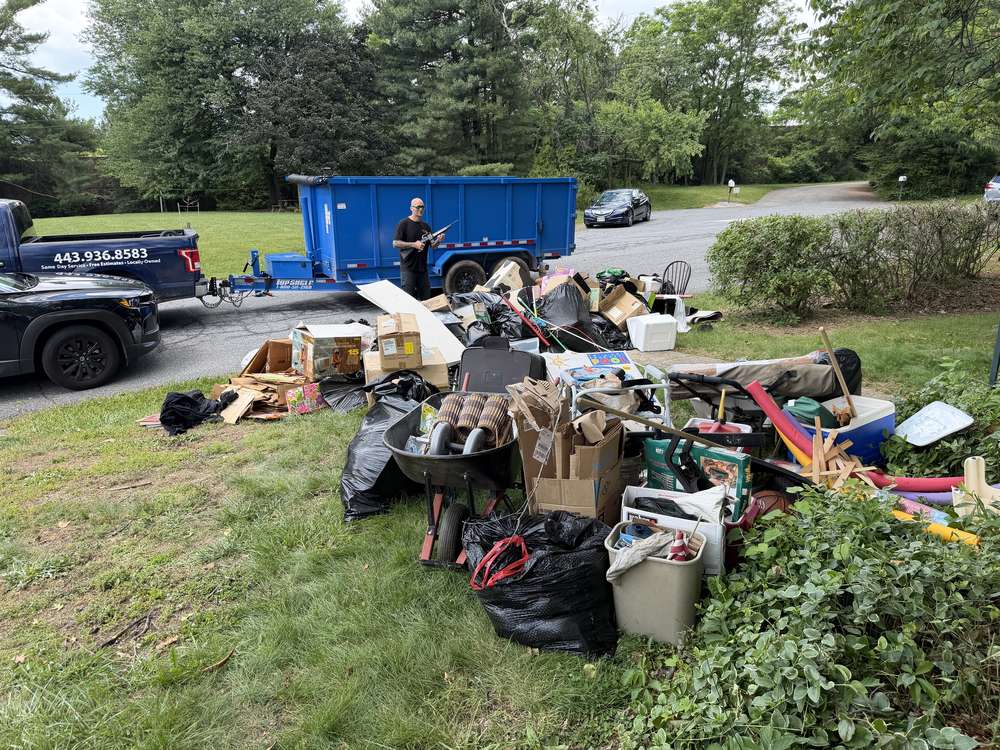 Whole household contents staged on the lawn during an estate cleanout in Ellicott City, MD