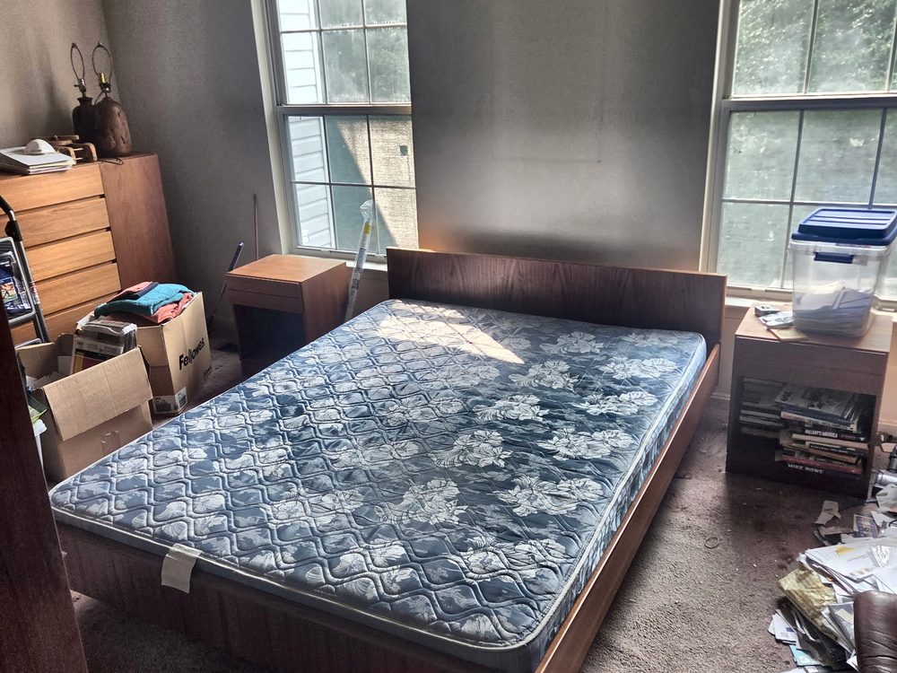 Same bedroom with the bags cleared and the mattress exposed after the estate cleanout in Odenton, MD