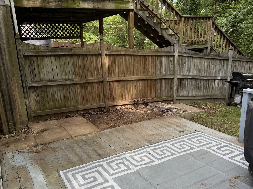 Open patio under the deck stairs after shed demolition in Pasadena, MD