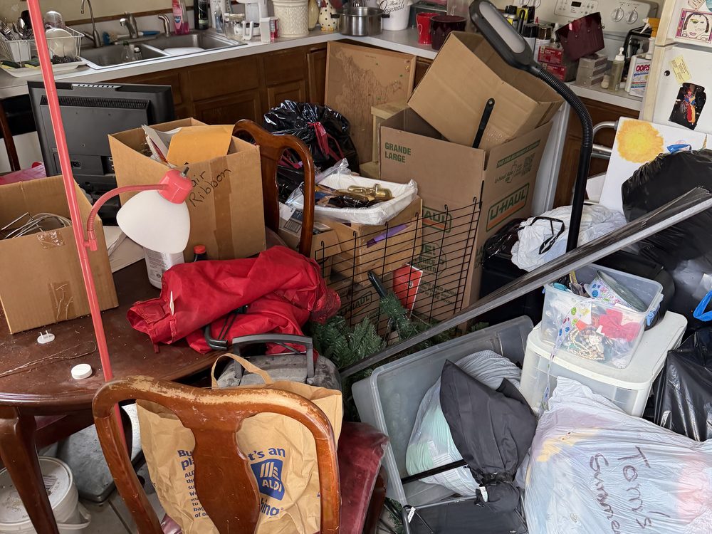 Kitchen packed floor to counter with boxes, bags and totes before a full estate cleanout on Severn Road in Severn, MD