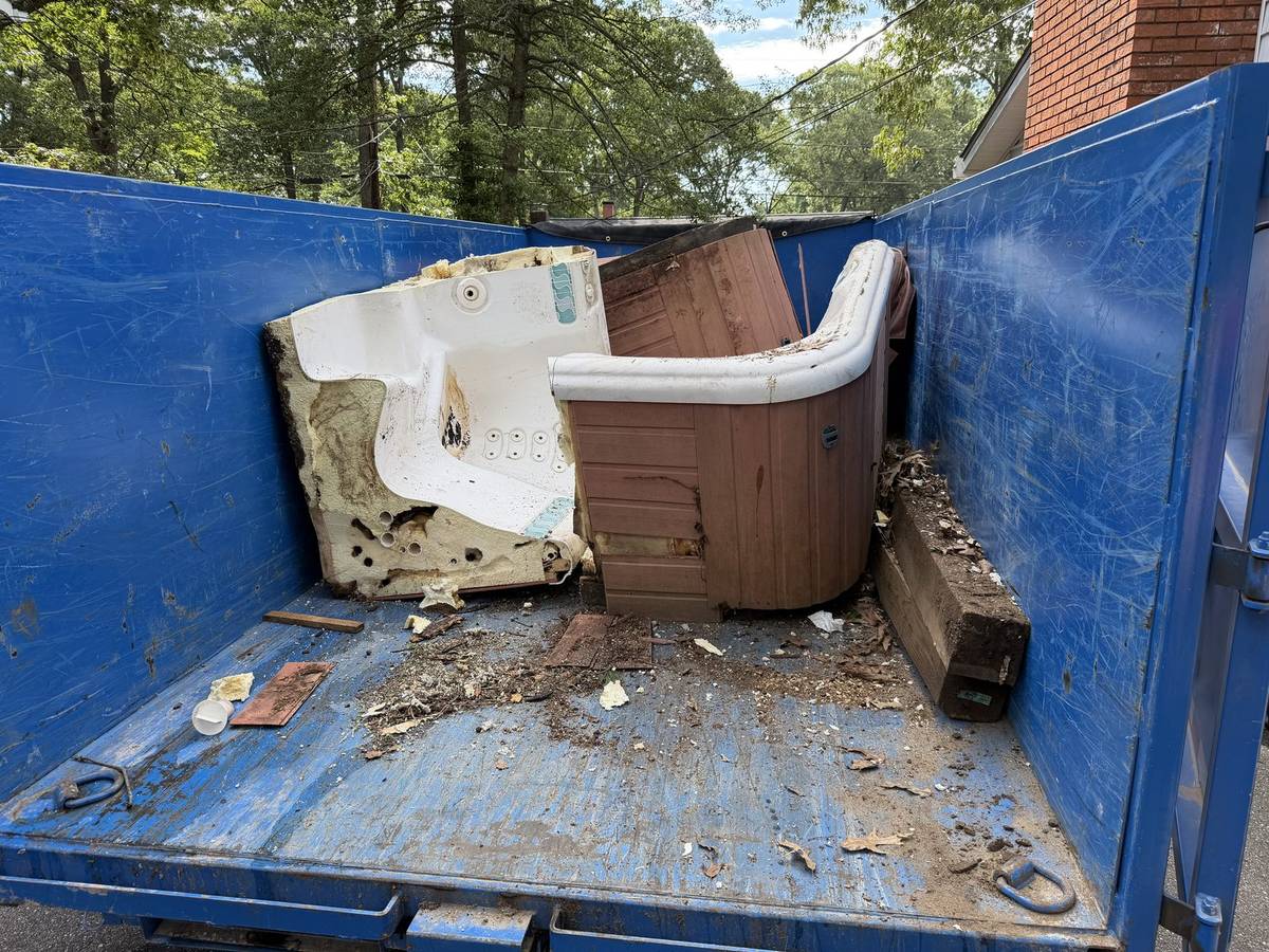 Hot tub cut into sections and loaded into a dump trailer during hot tub demolition in Severna Park, MD